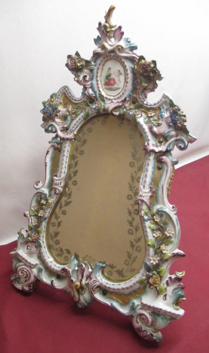 Late C19th porcelain framed easel mirror, the cartouche plate with etched border of flowers in an