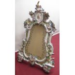 Late C19th porcelain framed easel mirror, the cartouche plate with etched border of flowers in an