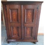 Early C19th Dutch ebonised strung oak side cabinet, the moulded top above two doors with four