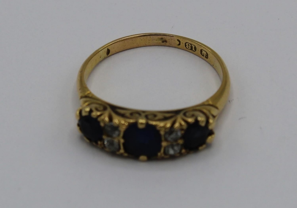 18ct yellow gold ring set with three sapphires and four diamonds in engraved mount, stamped 18ct, - Image 2 of 2