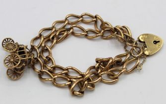 9ct gold double chain bracelet, with 9ct gold mail coach charm and padlock clasp, 35.5g