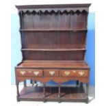 Geo. III open oak dresser, two tier planked back with moulded cornice and iron coat hooks, base with