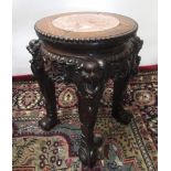 Small early C20th padouk jardiniere stand with marble inset circular top on four fruit carved