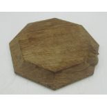Robert Mouseman Thompson of Kilburn - an oak octagonal small chopping board or teapot stand, moulded