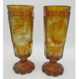 Pair of Bohemian amber glass Hunting goblets, tapering bowls etched in relief panels with Stag,
