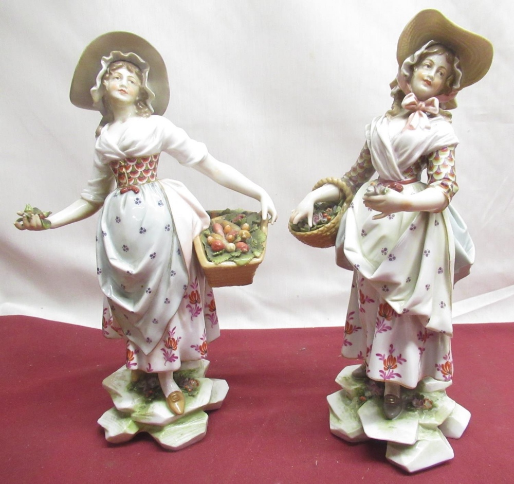 Pair of C20th Dresden porcelain models of female flower and produce sellers, both with baskets in