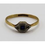 18ct yellow gold ring with square cut sapphire flanked by two diamonds in a platinum mount,