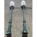 Pair of Victorian style green painted aluminium part fluted lamp posts, with ladder rest bar and