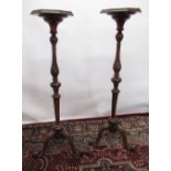 Pair of Queen Anne style walnut tripod torchères, circular tops on knopped baluster columns,