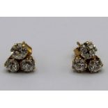 pair of 18ct yellow gold three stone diamond cluster earrings, with butterfly backs, stamped 750,