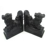 Pair of Chinese black marble bookends, carved as Dogs of Fo, on plinth bases, L14cm H17cm (A/F)