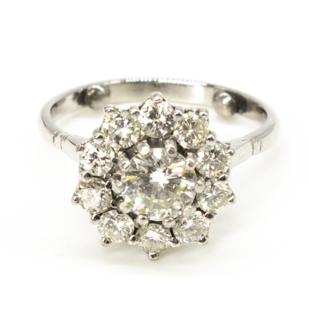 Diamond daisy ring, round cut claw set central diamond surrounded by ten smaller claw set round