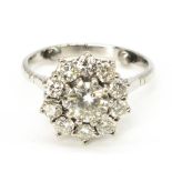 Diamond daisy ring, round cut claw set central diamond surrounded by ten smaller claw set round