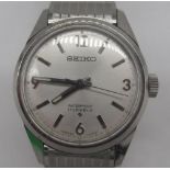 Seiko mid size hand wound wristwatch, stainless steel case on textured horizontal line Seiko