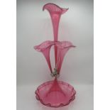Victorian style cranberry glass epergne with four flutes on a scalloped edged circular base, H53cm