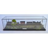 An OO gauge diorama with lead framed glass display case. Loco unknown manufacturer but is a