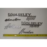 Five vintage chromed car manufacturers signs including Wolsey 6/110, Hillman Hunter, Austin of