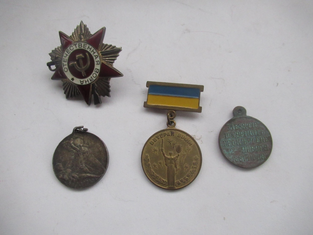 Three Russian medallions, one of Bolshevik revolution, and Russian cap badge (4)