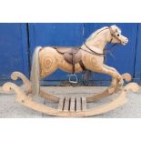 C20th rocking horse, ply construction on bow rocker base, cream mane and tail with leather saddle,