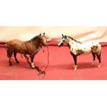 Royal Doulton Appaloosa stallion together with a Beswick brown stallion with harness (2)