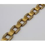 Cartier style yellow metal and diamond square link bracelet, set with one hundred and forty