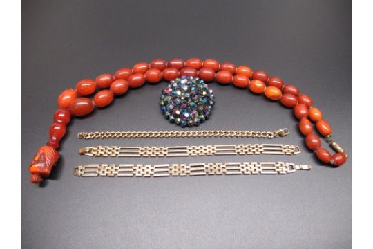 Amber graduated bead necklace with a resin tribal head pendant, a costume jewellery brooch and three - Image 1 of 4