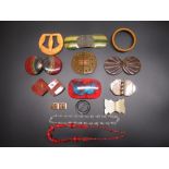 Collection of early C20th and later belt buckles and jewellery including a Bakelite black and orange