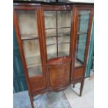 Edwardian inlaid mahogany inverted bow breakfront display cabinet with arched cresting on square