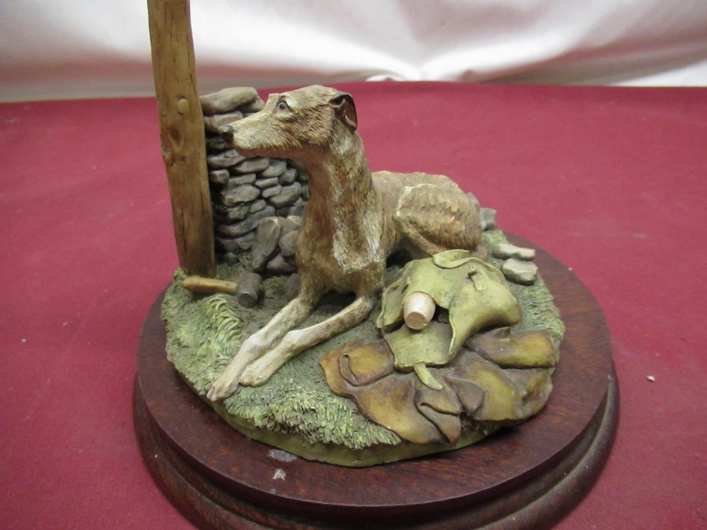 Large Border Fine Arts group of a seated lurcher beside on a stone wall, D18cm H13cm