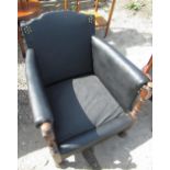 1930's brass nail rexine upholstered low armchair with turned arm supports on bun feet W66cm D65cm