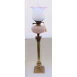 Early C20th brass Corinthian column oil lamp on stepped base with moulded pink opaline glass