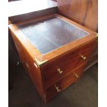 Campaign style mahogany side cabinet, brass bound inset glass top above two drawers on bracket feet,
