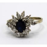 18ct white gold sapphire and diamond cluster ring, the central oval cut sapphire surrounded by seven