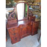 Victorian mahogany serpentine front dressing table, arched mirror on pierced scroll supports,