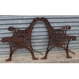 Pair of ornate bench ends with lion mask and floral patterns