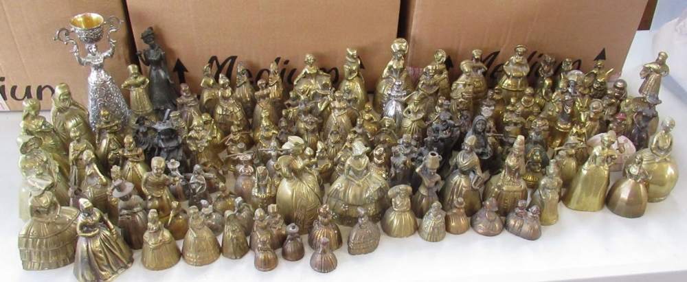 Collection of brass and metal bells modelled as ladies in farming and formal dress (3 boxes)