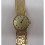 Ladies Omega 9ct gold hand wound wristwatch, signed brushed gold dial with applied baton markers,