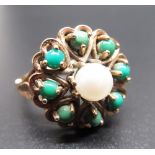 9ct yellow gold ring with set with a single pearl surrounded by eight green coloured round stones,