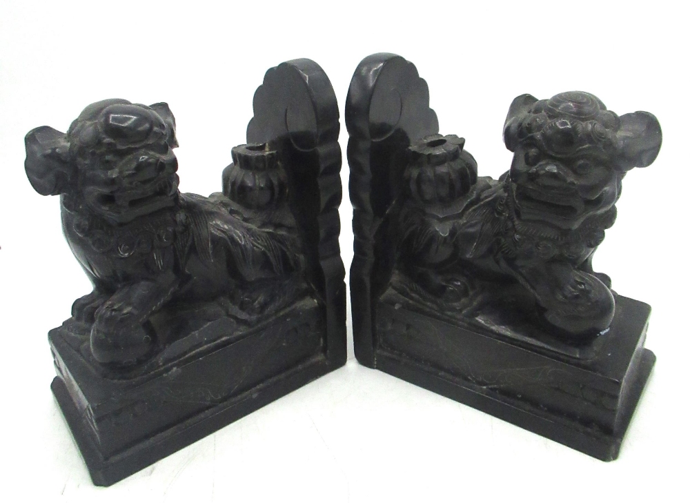 Pair of Chinese black marble bookends, carved as Dogs of Fo, on plinth bases, L14cm H17cm (A/F)