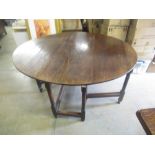 C19th oval oak gateleg dining table, two D shaped leaves on gun barrel turned and block supports