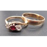 9ct yellow gold diamond and ruby crossover ring, set with a central brilliant cut ruby and two