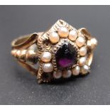 Yellow metal Mourning ring, the central amethyst surrounded by seed pearls (A/F) in a shield