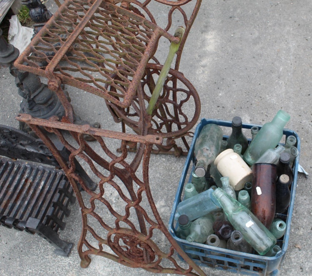 Large collection of vintage bottles of various styles and a Singer sewing machine stand
