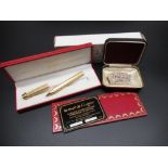 Les Must de Cartier cased ball point pen, boxed with authenticity card, and a pearl necklace with