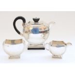 Geo.V Art Deco three piece hallmarked silver tea service in an stepped symmetrical half moon