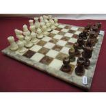 C20th polished marble chess board and pieces, board 36cm square