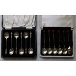 Two sets of silver coffee spoons, one apostle style and one coffee bean style