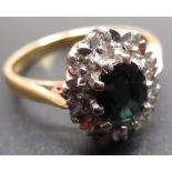 18ct yellow gold sapphire and diamond cluster ring, the central oval cut sapphire surrounded by a