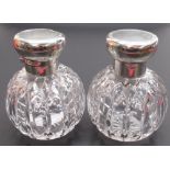 Pair of Geo.V hallmarked silver topped cut glass scent bottles, hinged covers with engine turned and