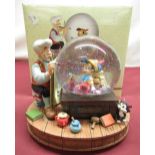 Boxed Disney Store Exclusive musical Snow Globe depicting Geppetto and Pinocchio playing I've Got No